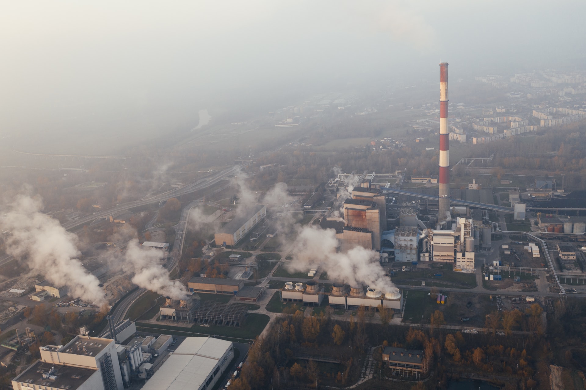 Toxic smoke pours out of industrial chimneys, polluting the air. The atmosphere has been steadily heating up to a dangerous temperature as a result of pollution like this.